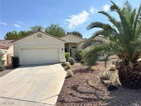 Inviting single-story home featuring desert landscaping and a two-car garage with a spacious driveway at 316 Lingering Ln, Henderson, NV 89012
