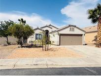 Charming single-story home featuring a well-kept front yard and a two-car garage at 3228 Jumping Hills Ave, Henderson, NV 89052