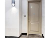 Condo front door with access number and modern sconce lighting at 38 E Serene Ave # 134, Las Vegas, NV 89123