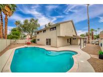 A sparkling pool and patio create a backyard oasis for relaxation and entertaining with mature desert landscaping at 4431 El Campana Way, Las Vegas, NV 89121