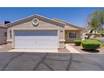 Charming single-story home with a well-maintained front yard and attached two-car garage at 5129 Midnight Oil Dr, Las Vegas, NV 89122