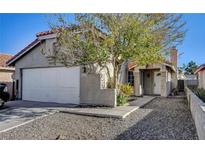 Charming single-story home with a two-car garage and a low maintenance xeriscape front yard at 5317 Walton Heath Ave, Las Vegas, NV 89142