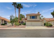 Charming two-story home with a tile roof, mature landscaping, and an attached two-car garage at 5609 Indian Ridge Dr, North Las Vegas, NV 89031