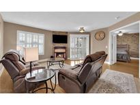 Cozy living room features a fireplace, comfortable seating, and ample natural light from shuttered windows at 6800 E Lake Mead Blvd # 2089, Las Vegas, NV 89156