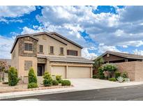 Two-story home with a three car garage and landscaped front yard is bathed in sunlight under a cloudy sky at 741 Flowing Meadow Dr, Henderson, NV 89014