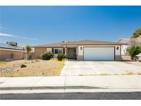 Charming single story home with a well maintained lawn, mature landscaping, and a two car garage at 7701 Pheasant Ln, Las Vegas, NV 89145