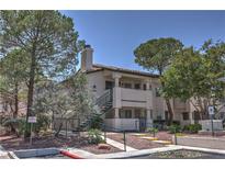 Traditional two-story condo featuring desert landscaping and covered balconies at 7961 Lions Rock Way # 202, Las Vegas, NV 89128