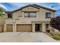 Stunning two-story home with a three-car garage and immaculate front yard landscaping at 8223 Saddleback Ledge Ave, Las Vegas, NV 89147