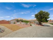 Charming single-story home featuring a desert-landscaped yard and a circular driveway leading to the arched front entry gate at 9025 S Tenaya Way, Las Vegas, NV 89113