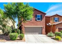 Charming two-story home featuring a well-maintained front yard, a driveway, and a two-car garage at 9236 Keystone Ridge Ave, Las Vegas, NV 89148