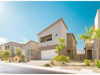 Modern two-story home with a neutral color palette and low-maintenance front yard landscaping at 9934 Iron Creek Ave, Las Vegas, NV 89178