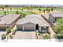 Beautiful single-story home featuring a three-car garage and lush landscaping overlooking a golf course at 1129 Via Della Curia, Henderson, NV 89011