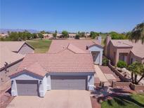 Charming home featuring a well-manicured lawn, desert landscaping, and an attached two-car garage at 1195 Golf Club Dr, Laughlin, NV 89029
