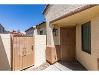 View of the front entrance featuring a decorative metal security door and adjacent gated entrance to the private front courtyard at 1905 Eskam St, Las Vegas, NV 89156