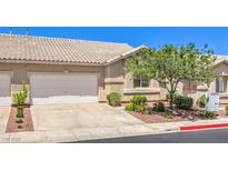 Charming home featuring a two-car garage, desert landscaping, and a tile roof at 201 Teller St, Henderson, NV 89074