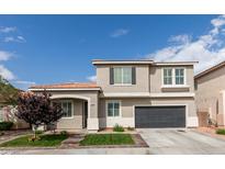 Inviting two-story home featuring a well-manicured lawn, attached two car garage, and neutral color scheme at 2418 Brockton Way, Henderson, NV 89074