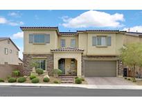 Charming two-story home featuring a stone facade, covered entry, and well-maintained landscaping at 404 Lost Horizon Ave, Henderson, NV 89002