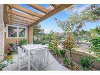 Inviting patio with pergola, seating area and lush landscaping, perfect for outdoor dining at 5008 Shoal Creek Cir, Las Vegas, NV 89113