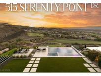 Enjoy backyard views featuring a pool, spa, fire pit, and putting green, with a golf course and mountain backdrop at 515 Serenity Point Dr, Henderson, NV 89012