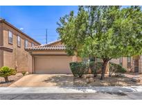 Charming single-story home with a two-car garage and desert landscaping on a sunny day at 5528 Stone Lagoon St, North Las Vegas, NV 89031