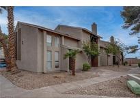 Inviting condo featuring a stucco exterior, desert landscaping, and a welcoming entrance at 573 Sellers Pl, Henderson, NV 89011