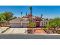 Stunning home boasts desert landscaping, a stone facade, and a three car garage at 6140 Galileo Dr, Las Vegas, NV 89149