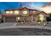 Elegant two-story home with a tile roof, desert landscaping, and a two-car garage at 7621 Hackensack Ct, Las Vegas, NV 89128