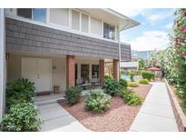 Charming front entrance with double doors, brick accents, and lush landscaping for a welcoming appeal at 794 Oakmont Ave # 106, Las Vegas, NV 89109