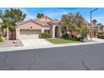 Charming single-story home featuring a well-manicured lawn, two-car garage and a welcoming entrance at 8612 Chiquita Dr, Las Vegas, NV 89128