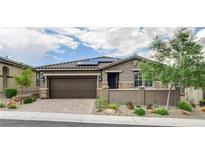 Charming single-story home with desert landscaping, a tile roof, solar panels and a two-car garage at 10182 Skye Run Ave, Las Vegas, NV 89166