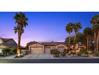 Charming single-story home with a three-car garage and beautiful desert landscaping with mature palms at 10674 Chillingham Dr, Las Vegas, NV 89183