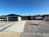 Charming single-story home featuring a spacious driveway and low-maintenance desert landscaping in the front yard at 1304 Bonita Ave, Las Vegas, NV 89104