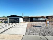 Charming single-story home featuring a well-maintained yard and a spacious driveway leading to the attached garage at 1304 Bonita Ave, Las Vegas, NV 89104