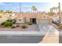 Charming single-story home with a well-maintained lawn, desert landscaping and a two-car garage at 155 Fallon Dr, Henderson, NV 89074
