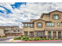 Beautiful exterior view of a tan two-story townhouse with a red tile roof and decorative shutters at 173 Petaluma Valley Dr, Las Vegas, NV 89138