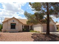 Charming one-story home showcasing a well-maintained front yard with a desert landscape and tile roof at 3001 Anna Bay Dr, Las Vegas, NV 89134