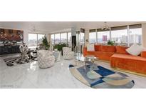 Bright, modern living room with city views from the large windows and unique colorful decor at 3111 Bel Air Dr # 12G, Las Vegas, NV 89109