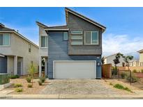 Striking two-story home with modern architectural details, attached two-car garage, and low maintenance landscaping at 3760 Paseo De Paz Ave, Las Vegas, NV 89115