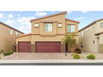 Two-story home with a neutral color scheme, three car garage, desert landscaping, and a brick driveway at 4039 Beech Fern Ave, North Las Vegas, NV 89084