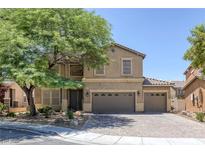 Two-story home featuring desert landscaping, two-car garage, and covered porch at 4225 Telstar Ct, North Las Vegas, NV 89032