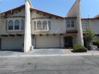 Charming townhome featuring a stucco exterior, a red tile roof, and attached garages at 5006 Schumann Dr, Las Vegas, NV 89146
