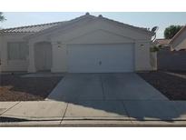 Charming single-story home with a well-maintained front yard and attached two-car garage at 5307 Wild Orchid St, North Las Vegas, NV 89031