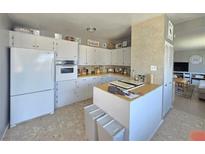 Bright kitchen features white cabinetry, wood countertops, and updated appliances at 5704 Heron Ave, Las Vegas, NV 89107