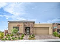 Stylish single-story home with stone accents, desert landscaping, and a two-car garage on a sunny day at 6728 Regency Ridge Ct, Las Vegas, NV 89148