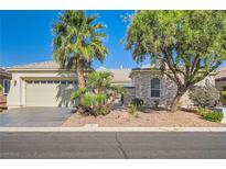 Charming single-story home with desert landscaping, palm trees, stone accents, and a two-car garage at 8305 Chapelle Ct, Las Vegas, NV 89131