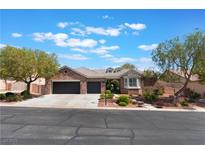 Charming brick home featuring a three-car garage, landscaped front yard, and a beautiful bay window at 8504 Mystic Night Ave, Las Vegas, NV 89143