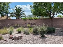 View of the community entrance sign amidst desert landscaping, creating an inviting first impression at 8873 Briar Bay Dr, Las Vegas, NV 89131