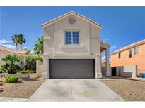 Charming stucco two-story home featuring a two-car garage and desert landscaping at 9328 Jumpin Juniper Ave, Las Vegas, NV 89129
