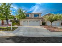 Charming two-story home with a three-car garage and desert landscaping at 9772 Galahad Point Ct, Las Vegas, NV 89147