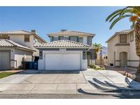 Charming two-story home showcasing a well-maintained lawn, attached two-car garage, and a classic tile roof at 1352 Angel Falls St, Las Vegas, NV 89142